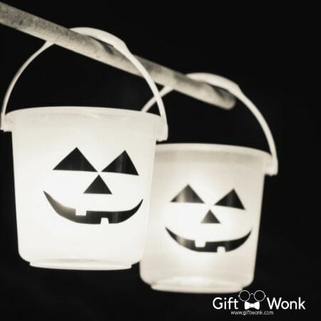 White Halloween buckets hanging from a rod