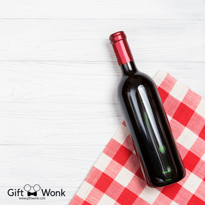 A bottle of wine on a picnic mat