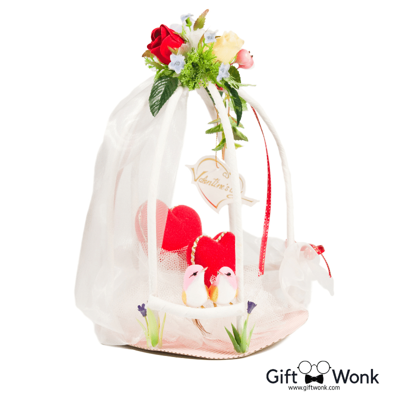 A Valentine's Day gift basket with two love birds 